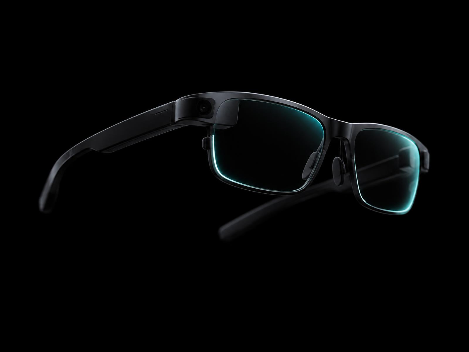 Sleek matte black AR glasses on a black background