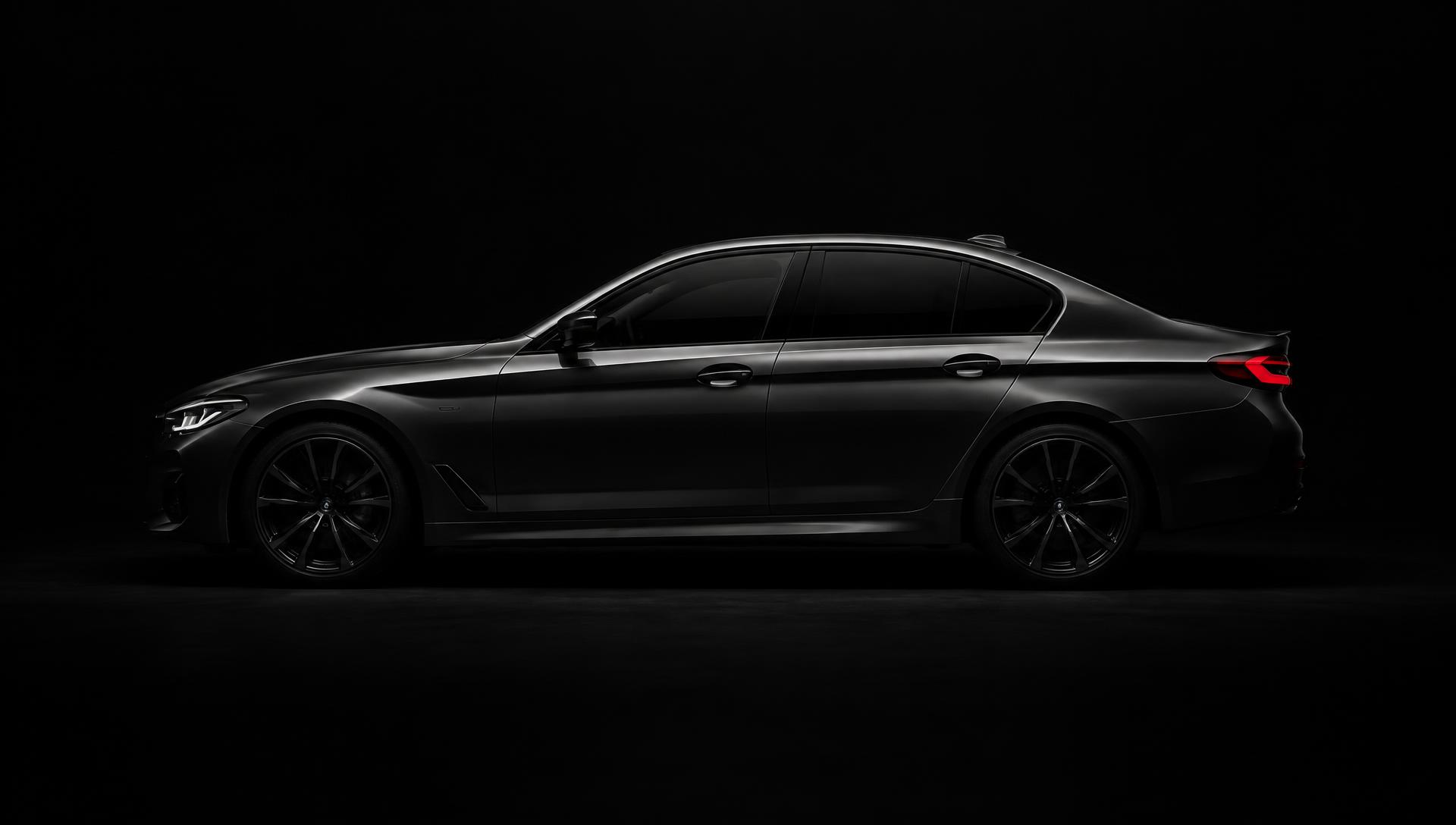 Side profile of a dark premium sedan lit by a single light streak